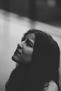 Woman looking up while standing in rain