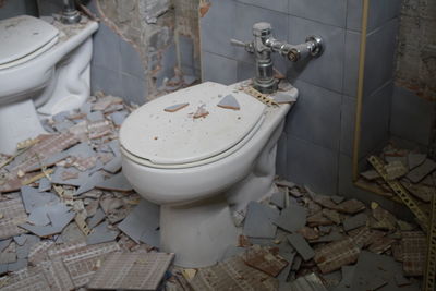 High angle view of toilets in damaged building