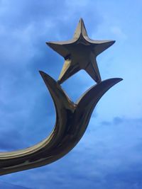 Low angle view of sculpture against blue sky