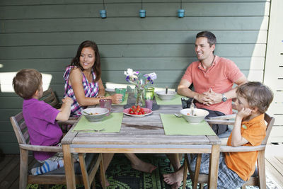 Family having breakfast together at porch