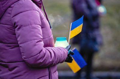 Ukrainian flags, candles and torches in the hands of protesters at the rally stand with ukraine