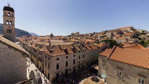 Buildings in town against clear sky