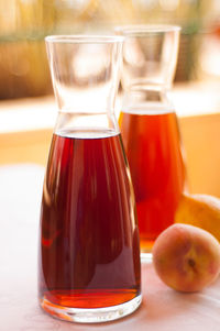 Close-up of fresh ice teas with peaches on table