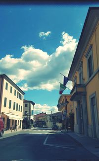 Buildings in city against cloudy sky