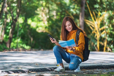 Portrait of young woman sitting on field