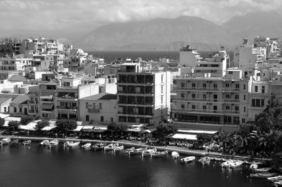 River amidst buildings in city against sky