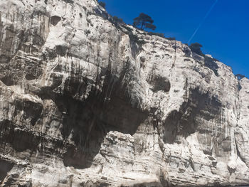 Low angle view of rock formation against sky