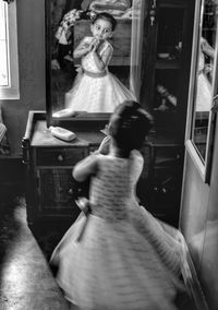 Rear view of woman standing at home