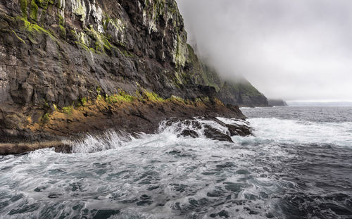 Scenic view of sea against rocks