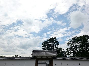 Low angle view of building against cloudy sky