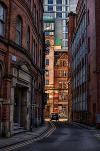 Vehicles on road along buildings