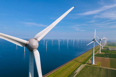 Low angle view of windmill against sky