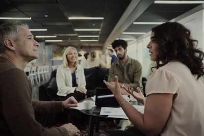 Group of business people having meeting in lobby