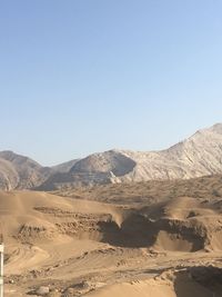 Scenic view of desert against clear sky