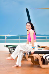 Portrait of young woman sitting on beach