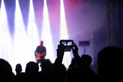 People photographing at music concert