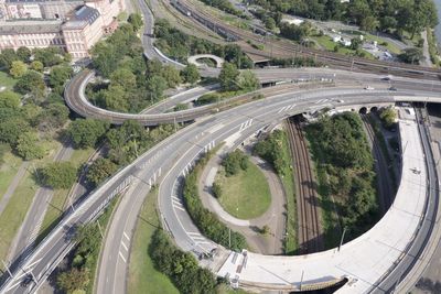 High angle view of highway amidst trees in city