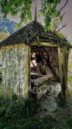 Abandoned built structure against trees