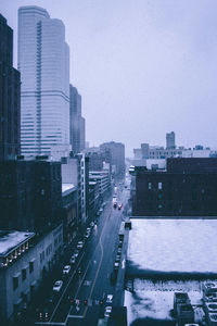 High angle view of city street and buildings against sky
