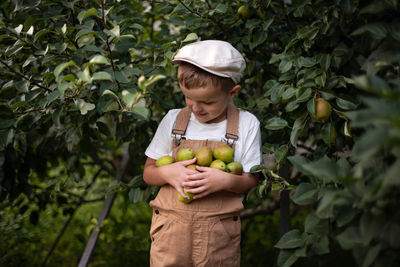 Full length of a boy standing against plants