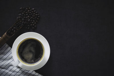 Close-up of coffee cup against black background