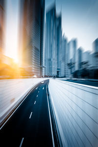 Empty road in city against sky