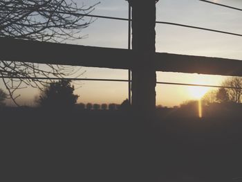 Silhouette of power lines at sunset