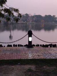 Bridge over lake against sky at dusk