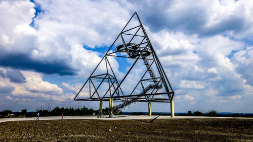 Low angle view of cranes against sky