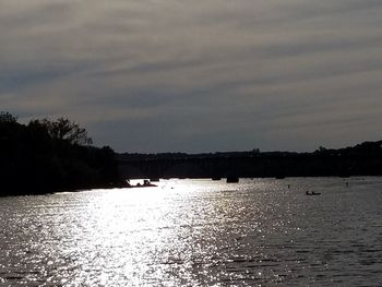 Scenic view of river against sky at sunset