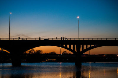 Silhouette of suspension bridge at night