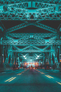 Illuminated bridge in city at night