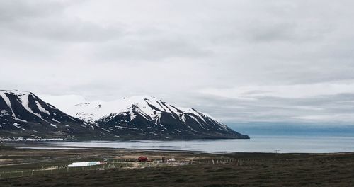 Scenic view of mountains against cloudy sky