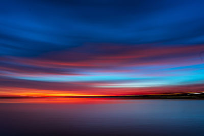 Scenic view of sea against romantic sky at sunset