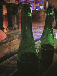 Close-up of beer bottles on table