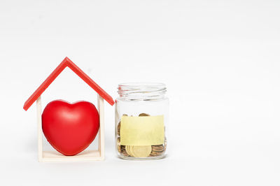 Close-up of red heart shape over white background