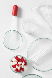 High angle view of glasses on table against white background