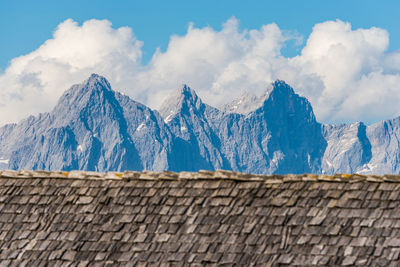 Scenic view of snowcapped mountains against cloudy sky