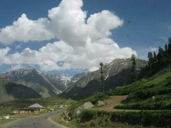 Scenic view of mountains against cloudy sky