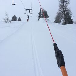 Ski lift against sky during winter