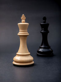 Close-up of chess pieces on gray background
