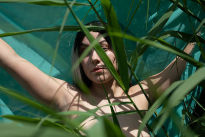 Portrait of young woman lying on swimming pool