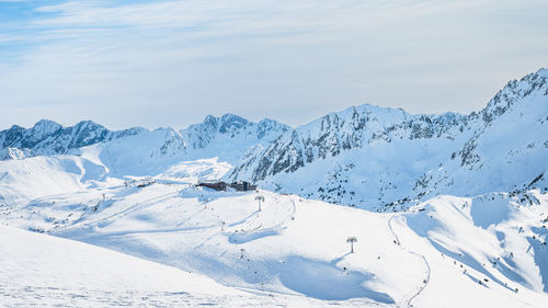 Ski lift cross centre on a snowy peak in beautiful winter scenery, andorra