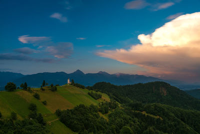 Scenic view of green mountains against sky