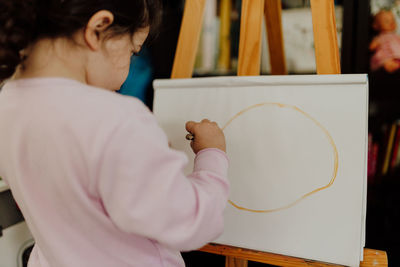 Cute girl painting at home