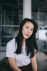 Portrait of a beautiful young woman standing outdoors