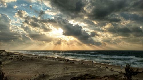 Scenic view of beach against sky during sunset