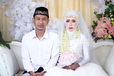 Portrait of young couple during wedding ceremony