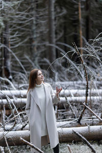 Woman standing on snow covered land
