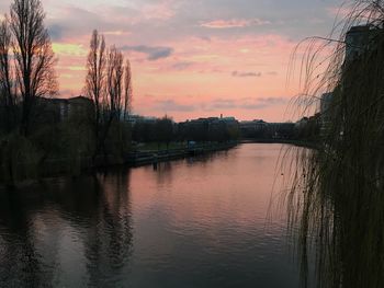 Scenic view of river against sky at dusk